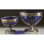 TWO OLD SHEFFIELD PLATE WIRE WORK CREAM AND SUGAR BOWLS with sapphire blue liners.