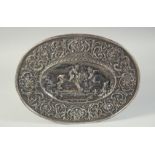 A GOOD CONTINENTAL SILVER OVAL DISH repousse with scrolls, a lion and two cupids. 14ins long, 11.