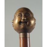 A WOODEN WALKING STICK with brass FOUR FACES HANDLE.