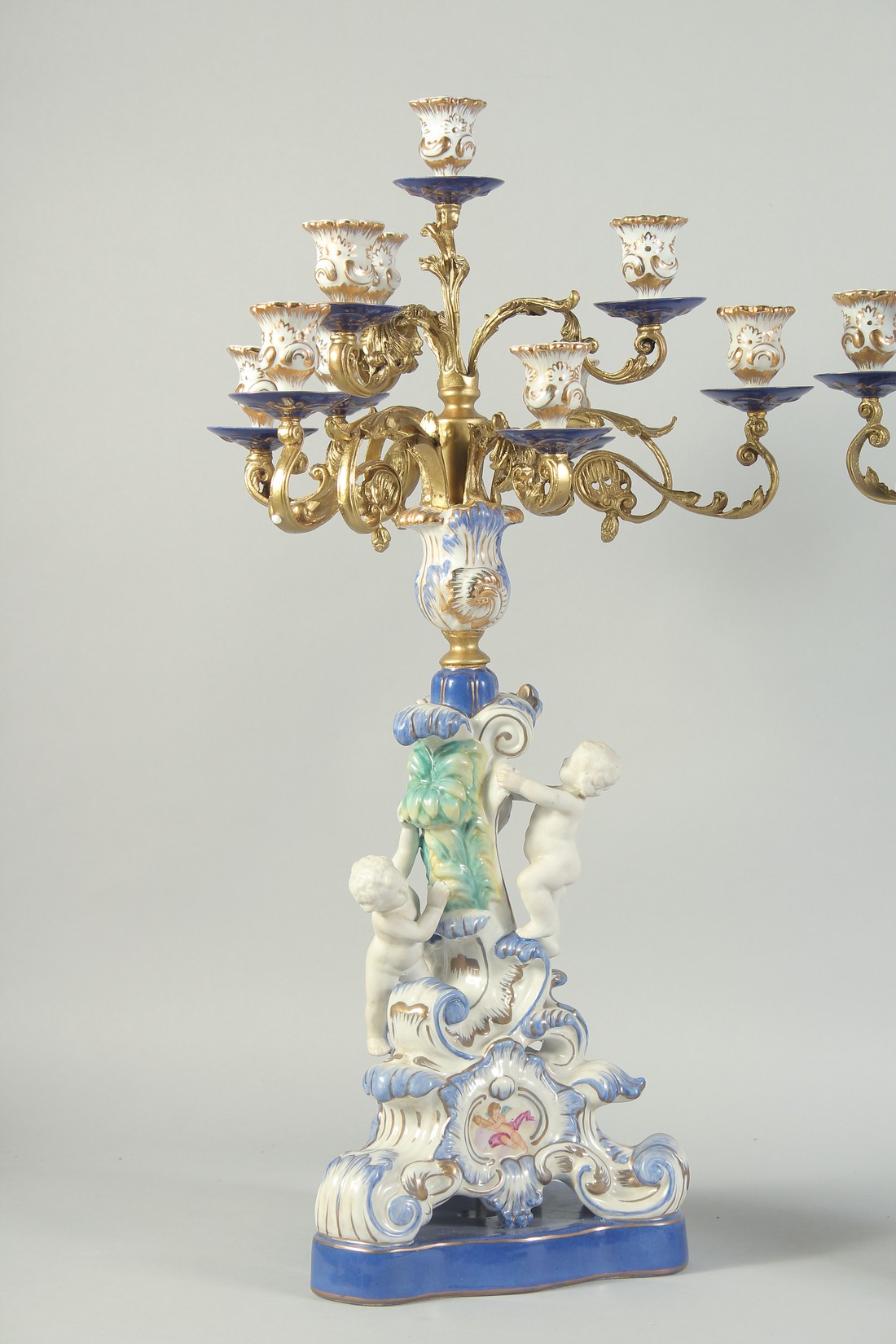 A GOOD PAIR OF SEVRES STYLE EIGHT BRANCH CANDELABRA with cupid support on blue bases. 1ft 11ins - Image 2 of 5