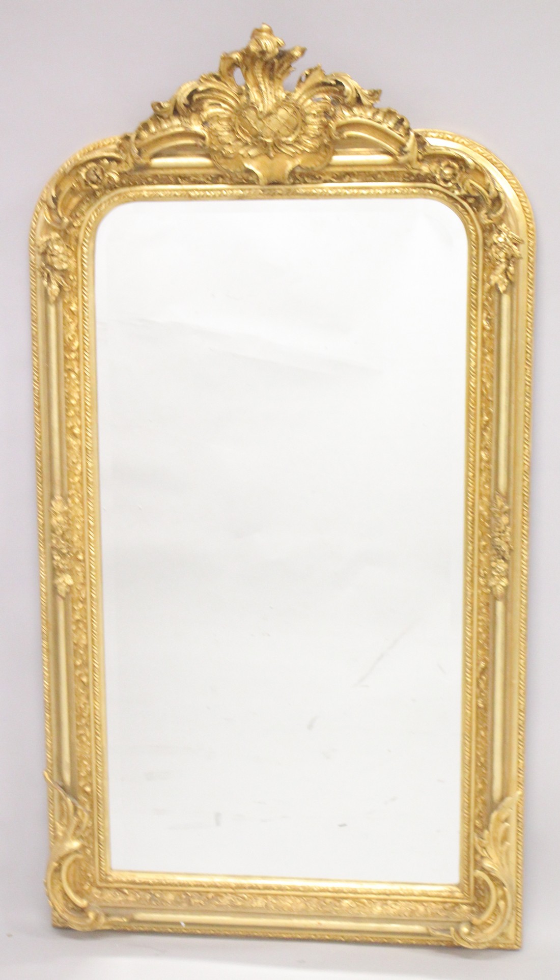 A LARGE GILTWOOD MIRROR. 5ft 2ins high, 2ft 9ins wide.