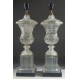 A GOOD PAIR OF GLASS TWIST URN SHAPED PEDESTAL LAMPS on a marble base. 23ins high.