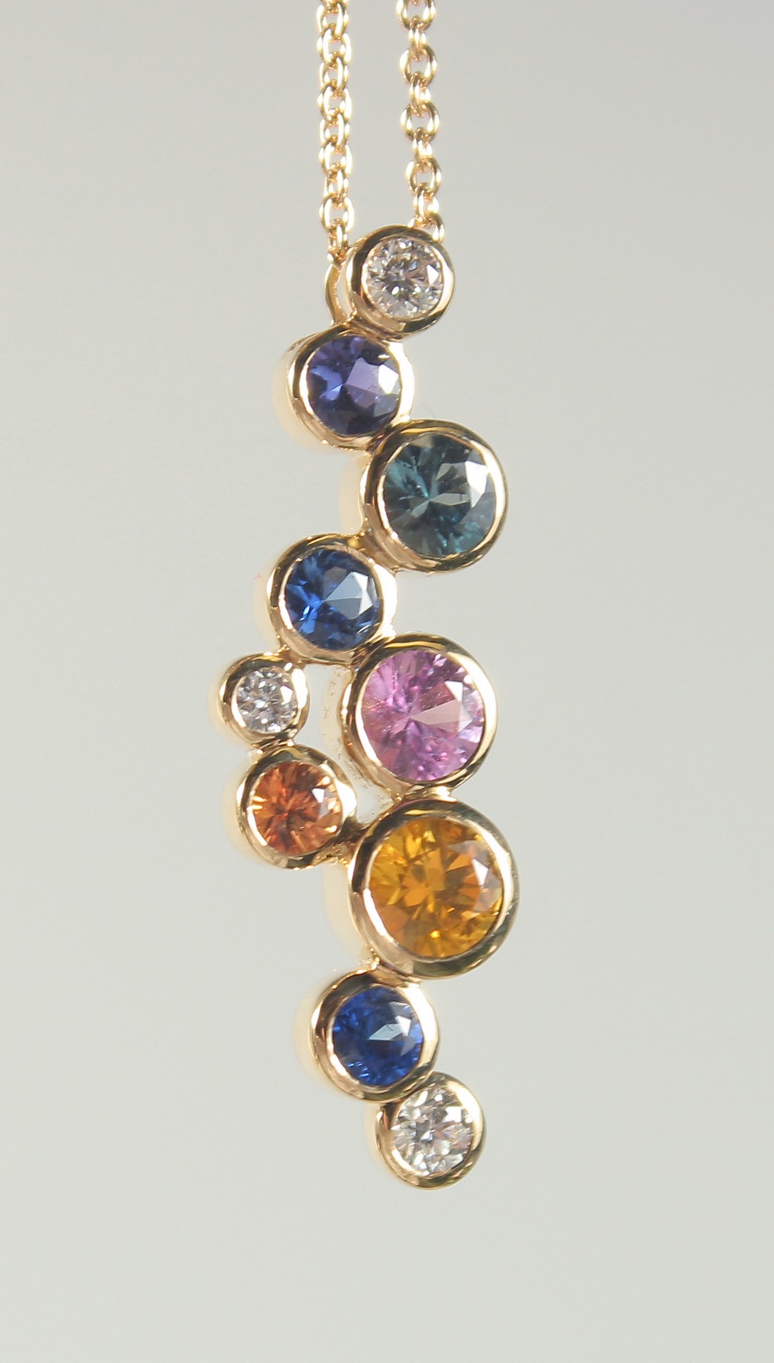 A GOOD 18CT GOLD MULTI SAPPHIRE AND DIAMOND PENDANT, one gold chain.