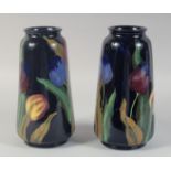 A PAIR OF ROYAL STANLEY WARE BLUE GROUP VASES painted with tulips. 10ins high.