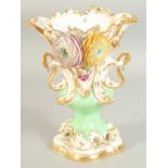 A GOOD LARGE FLOWER ENCRUSTED URN with gilt decoration, pierced handles and painted with flowers.
