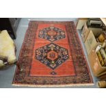 A PERSIAN RUG red ground with two large medallions. 6ft 2ins x 4ft 2ins.