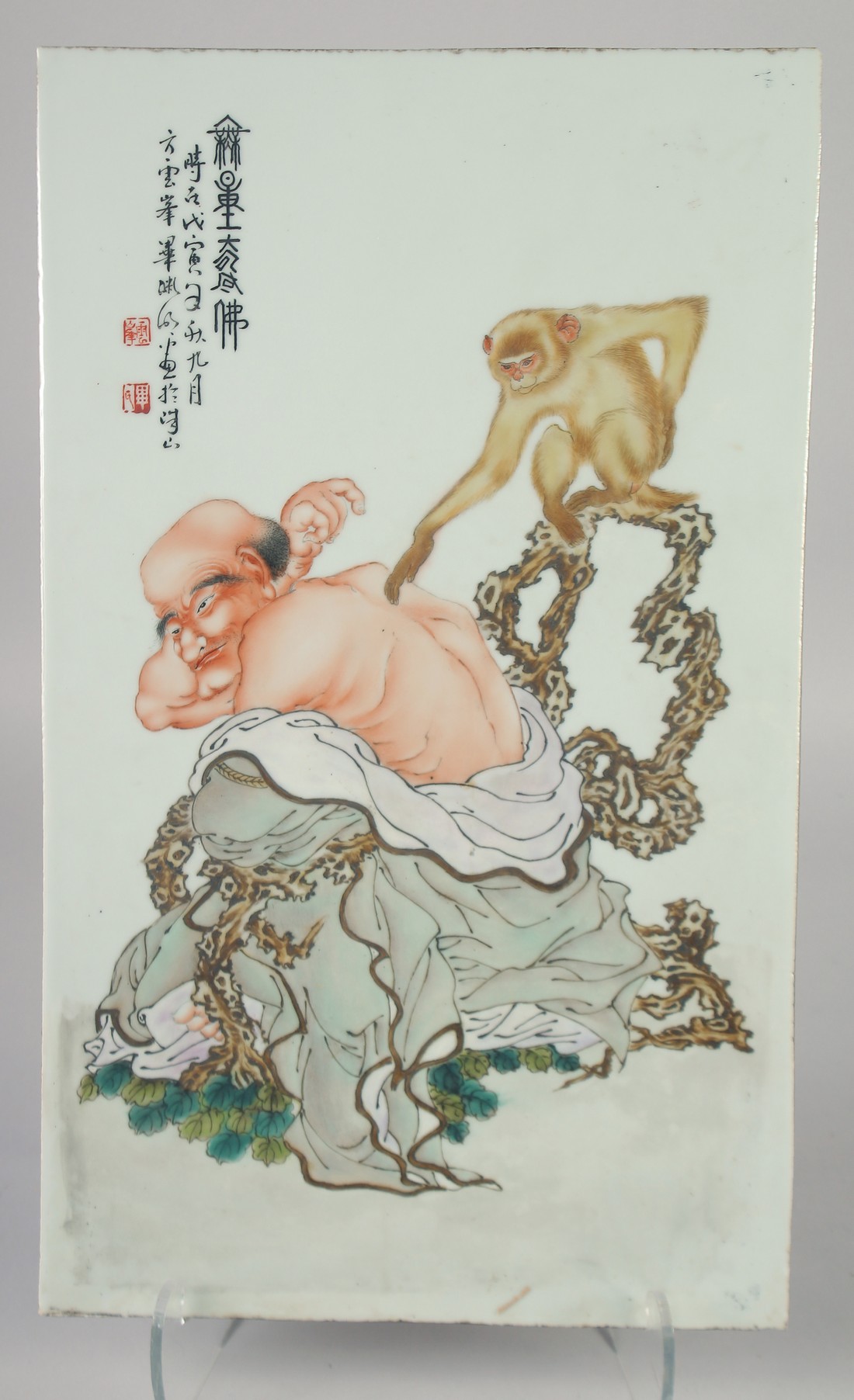 A LARGE CHINESE PORCELAIN PLAQUE, painted with a monk and monkey, inscribed, with two red seals,