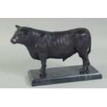 A BRONZE BULL on a marble base. 10ins high.