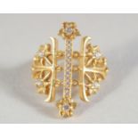 AN 18CT GOLD LALOUNIS DIAMOND SET CROSS PIERCED RING.