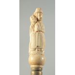 A CARVED BONE HANDLED WALKING STICK "EROTIC".