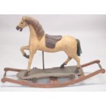 A OLD CARVED WOODEN ROCKING HORSE. 4ft high.