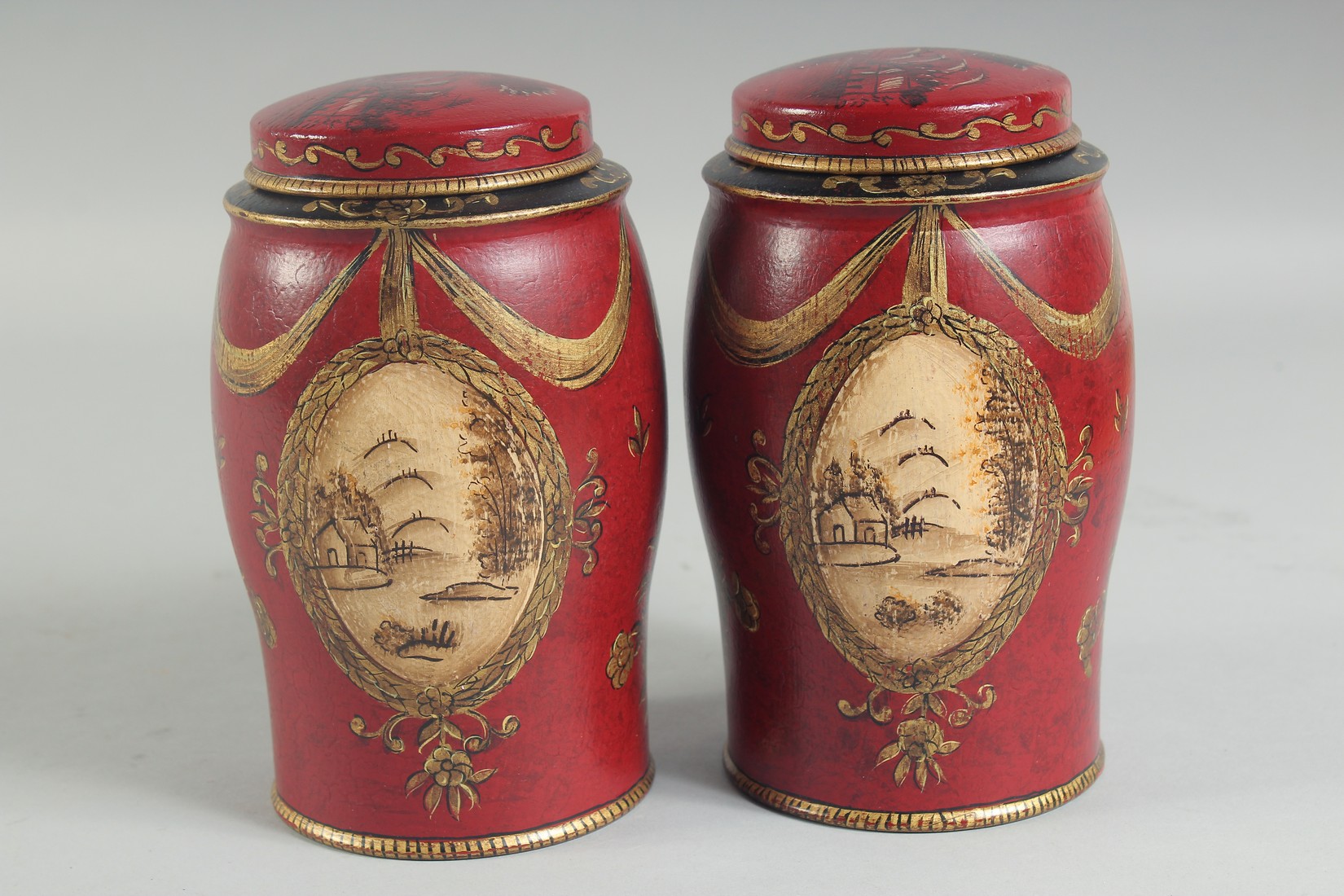 A SMALL PAIR OF RED TOLEWARE TINS AND COVERS. 7ins high. - Image 3 of 4