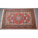 A VERY GOOD PERSIAN FLORAL RUG on a red ground. 135cm x 210cm.