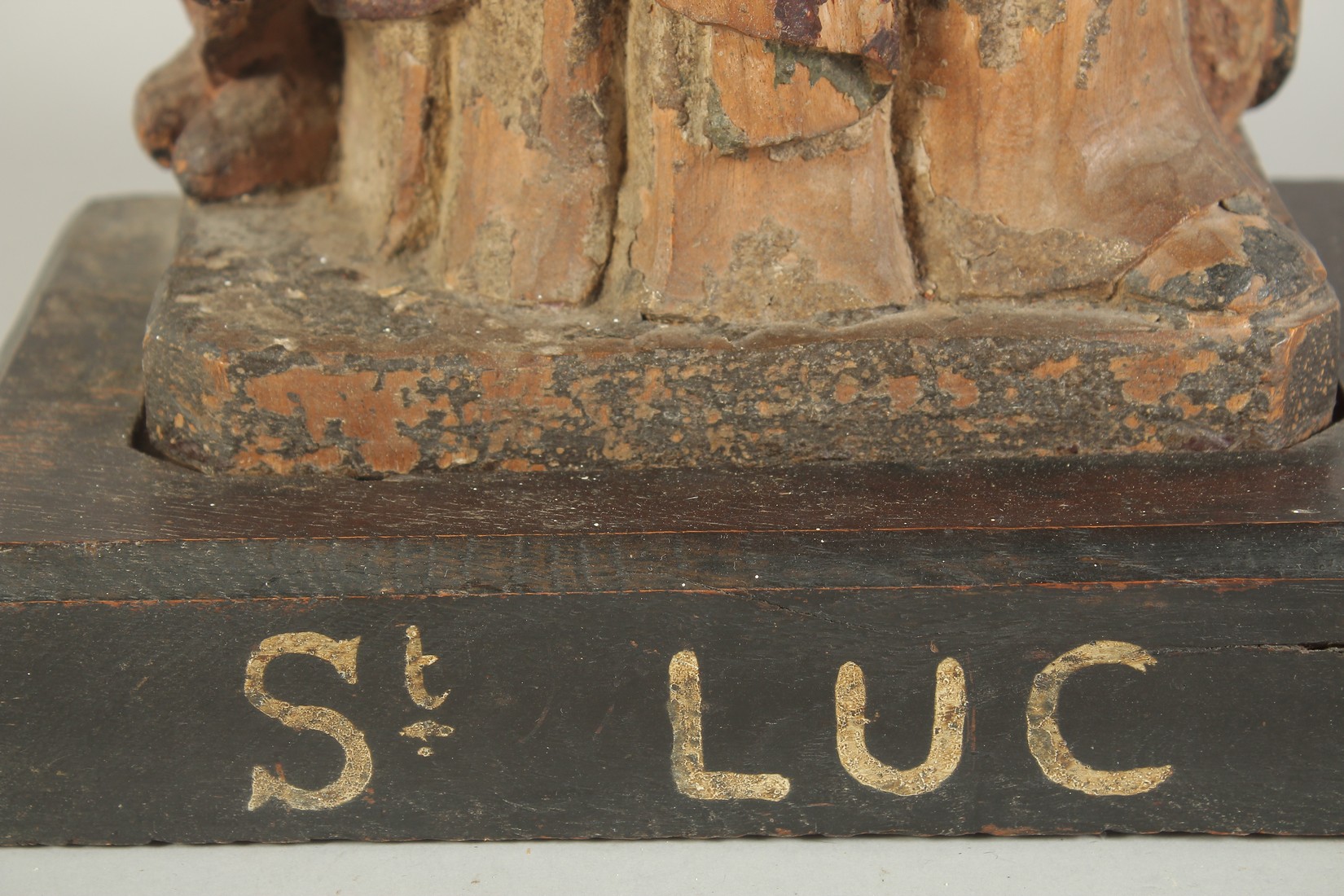 A GOOD 17TH CENTURY CARVED WOOD AND POLYCHROME FIGURE, ST. LUC, on a wooden base. 1ft 11ins high. - Image 4 of 7