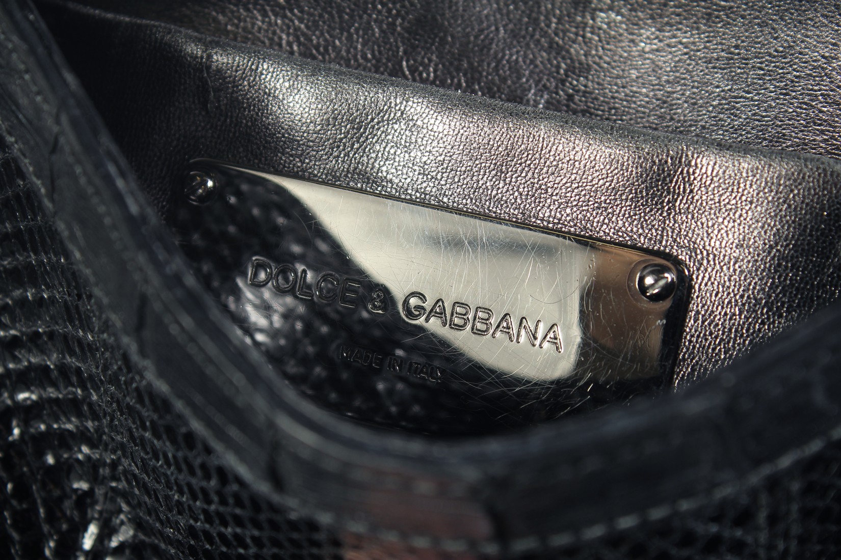 A GOOD DOLCE AND GABBANA BLACK CROCODILE OR SNAKESKIN BAG. 9ins long, 7ins high, in a dust bag. - Image 6 of 7