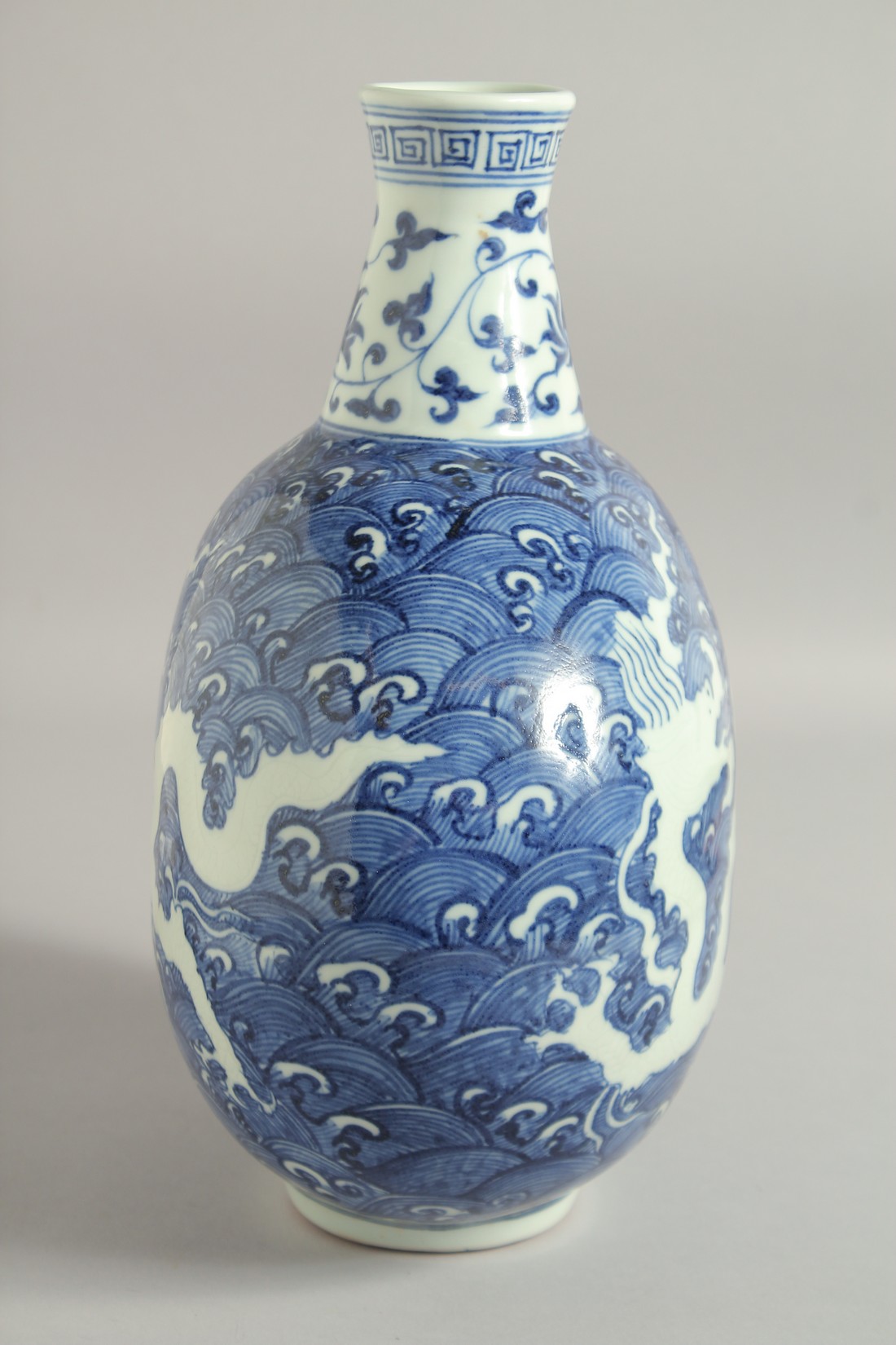 A CHINESE BLUE AND WHITE PORCELAIN MOON FLASK VASE, with incised white dragon on stylised waves, - Image 4 of 6