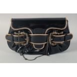 A SMALL FENDI BLACK AND GILT PATENT BAG the front with three buckles. 8ins long, 5ins high.
