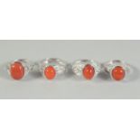 FOUR SILVER AND CORAL RINGS,