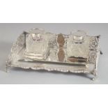 A RECTANGULAR SILVER TWO BOTTLED INKWELL with pierced sides. 7.25ins long. London 1913, silver: