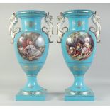 A LARGE PAIR OF LIGHT BLUE SEVRES STYLE TWO HANDLED VASES with griffin handles and oval classical