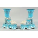 A PAIR OF PORCELAIN LIGHT BLUE BOARS HEAD SPILL VASES. 11ins high.