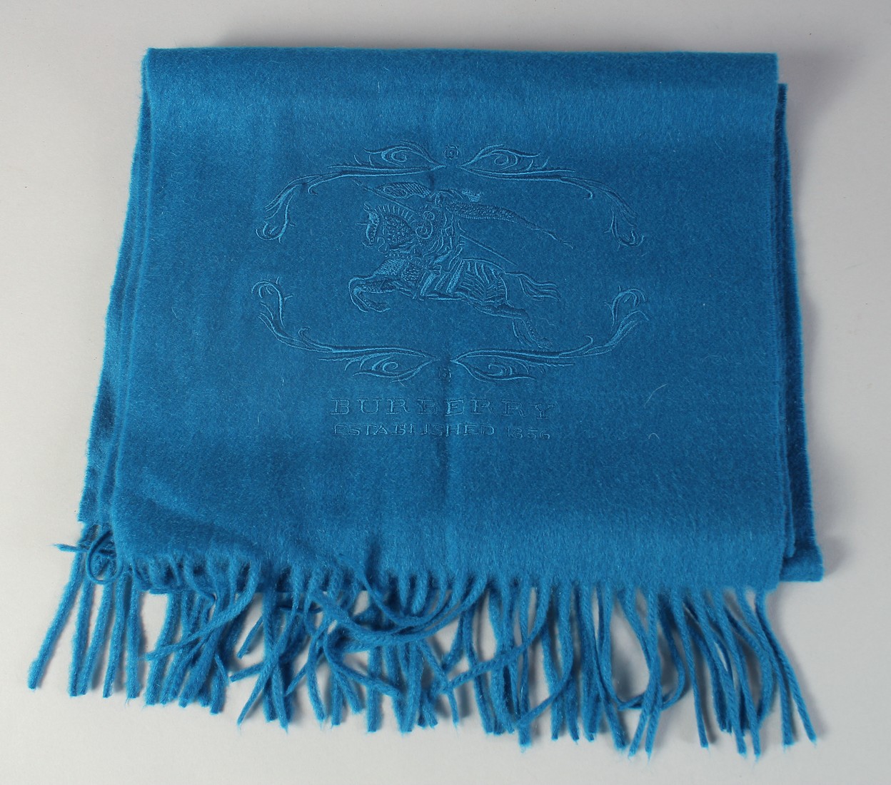 A BURBERRY BLUE CASHMERE SCARF with horse and rider design, 4ft long.