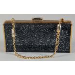 A JUDITH LEIBER, NEW YORK BLACK BEAD EVENING BAG, with gilt interior pocket mirror in a cloth bag.