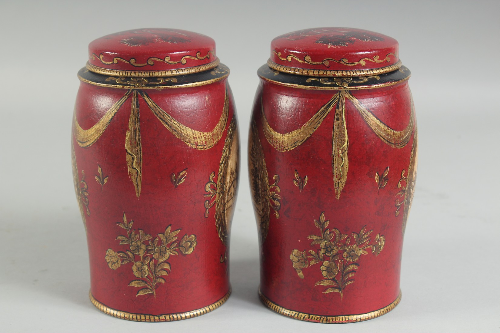 A SMALL PAIR OF RED TOLEWARE TINS AND COVERS. 7ins high. - Image 4 of 4
