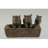 A JAPANESE BRONZE PIGS IN A TROUGH. 4cm