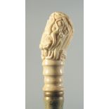 A CARVED BONE HANDLED WALKING STICK "EROTIC".