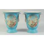 A PAIR OF SEVRES STYLE LIGHT BLUE VASES with panels of classical scenes. 10ins high.