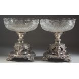 A VERY GOOD PAIR OF SILVER PLATED CUT GLASS TABLE CENTRE PIECES, the bases with elephants,