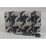 A GOOD CHANEL BLACK AND WHITE WOVEN TWEED/FABRIC BAG with black leather interior with entwined
