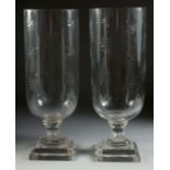 A GOOD PAIR OF STAR CUT GLASS HURRICANE LAMPS on square bases. 15.5ins high.