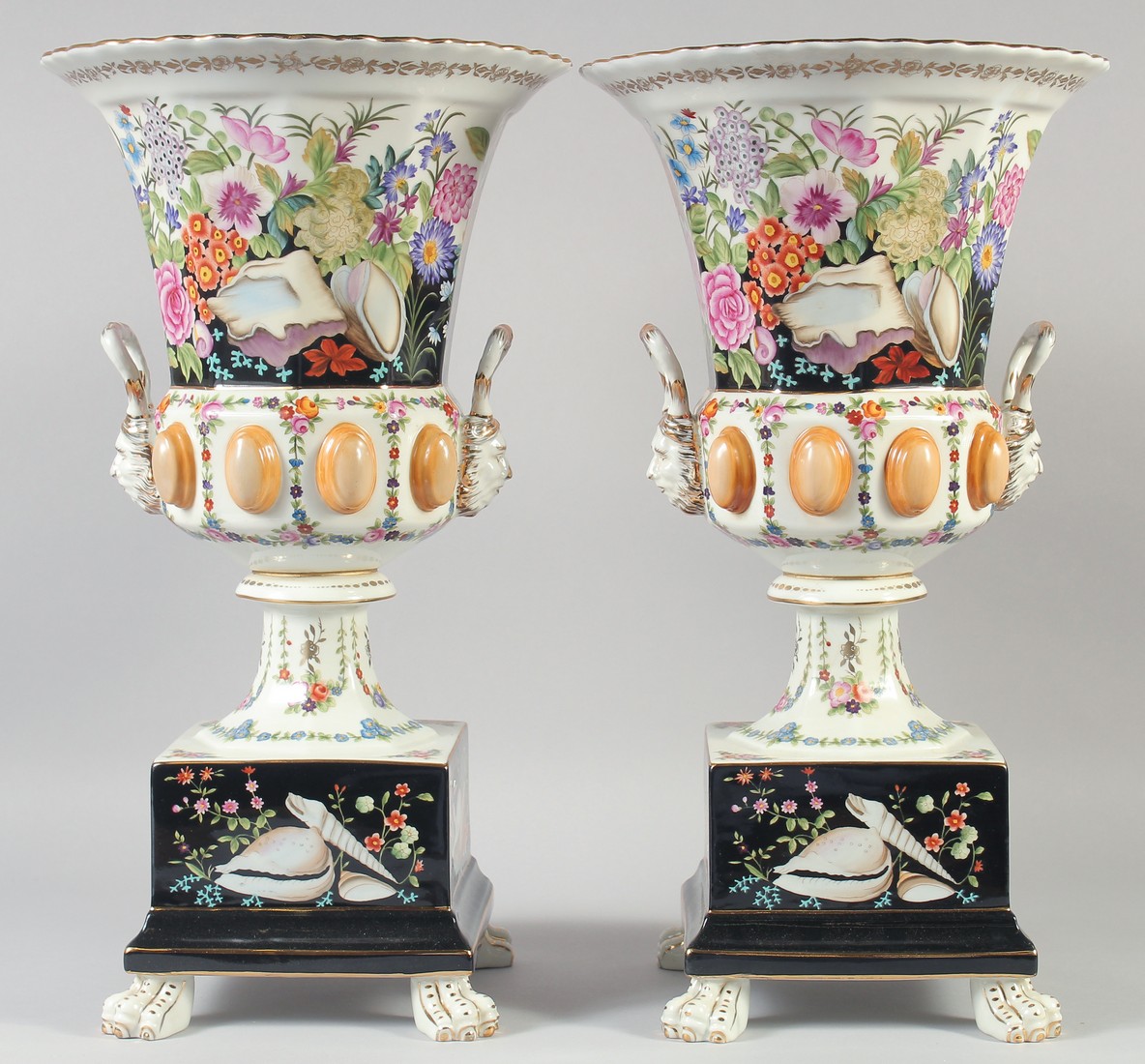 A GOOD LARGE PAIR OF CONTINENTAL TWO HANDLED URN SHAPED VASES ON STANDS on claw feet. 18ins high.