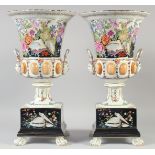 A GOOD LARGE PAIR OF CONTINENTAL TWO HANDLED URN SHAPED VASES ON STANDS on claw feet. 18ins high.