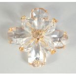 A LARGE CHANEL EIGHT PETAL FLOWER BROOCH with CC in diamante, in a Chanel box. 4.5cm diameter.