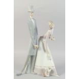 A LARGE LLADRO PORCELAIN GROUP, TWO LONG FIGURES, a dog at their feet. 20ins high.