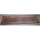 A LONG PERSIAN RUNNER RUG rich blue ground with Boteh decoration. 40cm x 108cm.