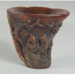 A CHINESE CARVED HORN LIBATION CUP. 6ins high.