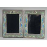 A PAIR OF ART DECO DESIGN SILVER AND ENAMEL PHOTOGRAPH FRAMES. 7.5ins x 5.5ins.