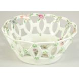 A 1ST PERIOD WORCESTER PORCELAIN OVAL PIERCED BASKET painted with flowers. 6.5ins diameter.