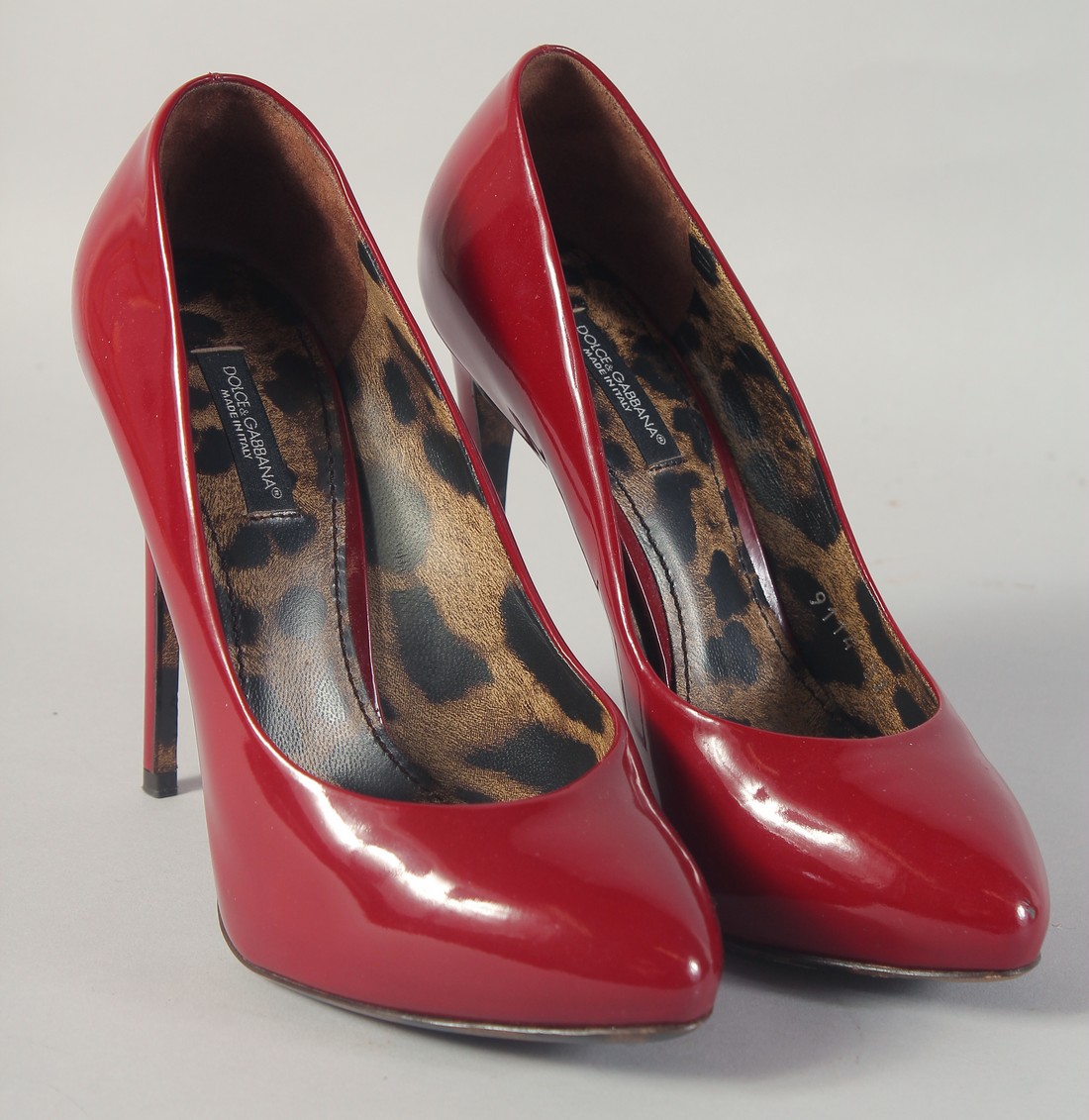 A PAIR OF DOLCE AND GABBANA RED HIGH HEEL SHOES. Size 37.