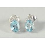 A PAIR OF 18CT WHITE GOLD AQUAMARINE AND DIAMOND EARRINGS.