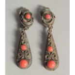 A PAIR OF SILVER AND CORAL EARRINGS.