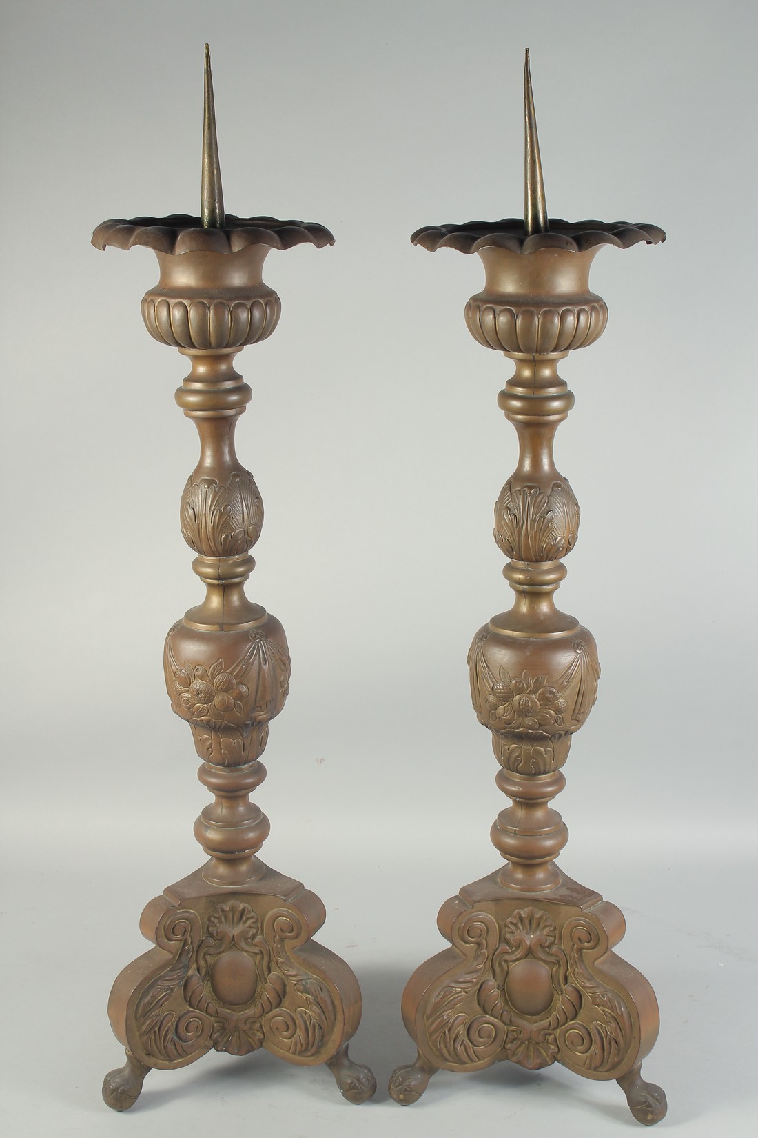 A LARGE PAIR OF DUTCH BRONZE PRICKET CANDLESTICKS. 3ft high.