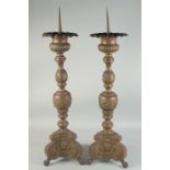 A LARGE PAIR OF DUTCH BRONZE PRICKET CANDLESTICKS. 3ft high.