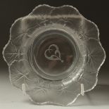 A LALIQUE BOWL 3cm deep, the sides with flowers. Signed, 15cm diameter in a Lalique box.