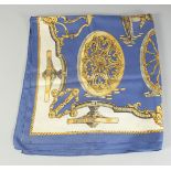 A HERMES SILK SCARF. Blue with wheels. 2ft 9ins x 3ft in a Hermes box.