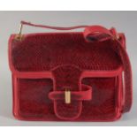 A VINTAGE PIERRE CARDIN OF PARIS RED SNAKESKIN BAG. 10ins long, 8.5ins deep with long handle, in a